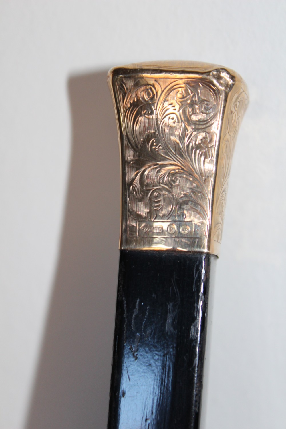 A very stylish gold topped walking stick 