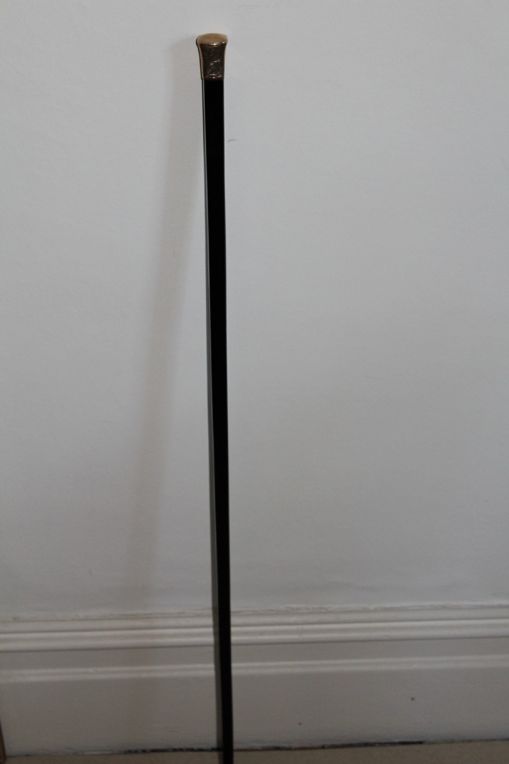 A very stylish gold topped walking stick  View V