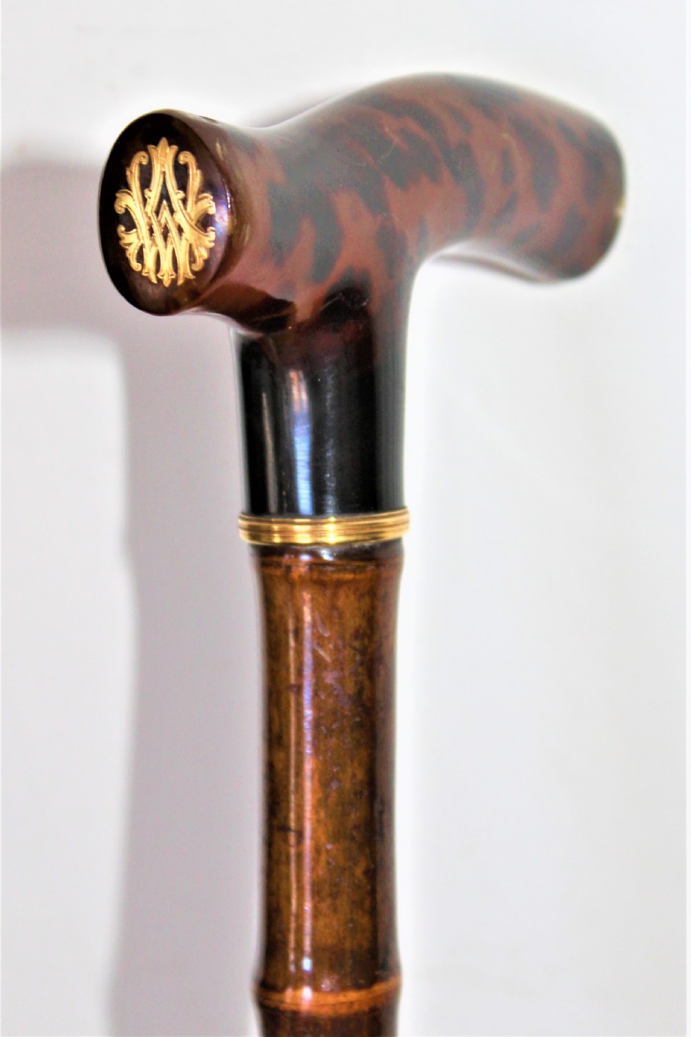 A very smart walking stick with a tortoiseshell handle 