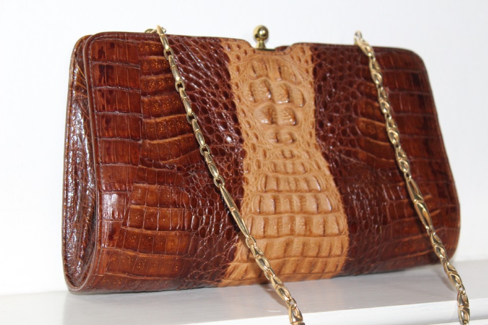 A 1930s Art Deco two-tone brown alligator skin handbag featuring a textured central hornback panel, top clasp closure, and a gilt metal chain strap. View VI
