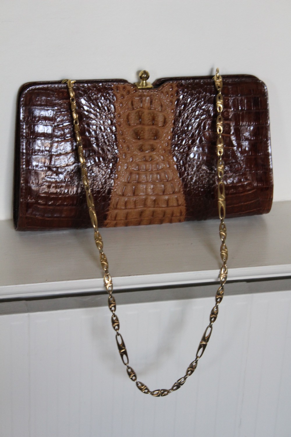 A 1930s Art Deco two-tone brown alligator skin handbag featuring a textured central hornback panel, top clasp closure, and a gilt metal chain strap. View VII