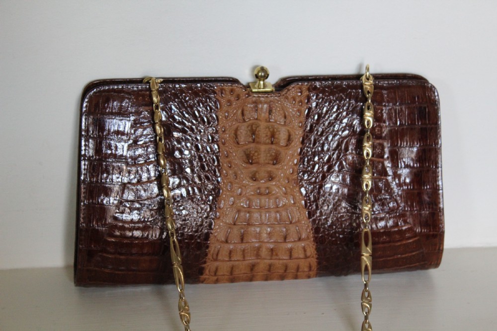 A 1930s Art Deco two-tone brown alligator skin handbag featuring a textured central hornback panel, top clasp closure, and a gilt metal chain strap. View X
