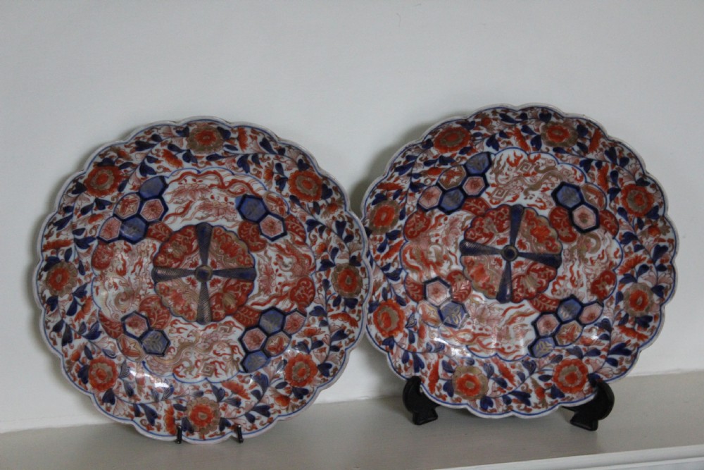 A pair of very finely painted and gilded imari plates
