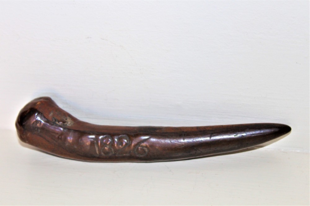 An early 19th-century curved wooden sailors fid featuring the carved date 1826 on its smooth polished body. View V