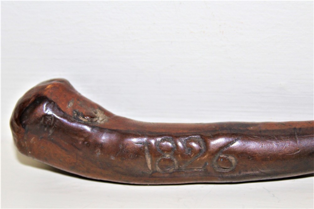 An early 19th-century curved wooden sailors fid featuring the carved date 1826 on its smooth polished body. View II