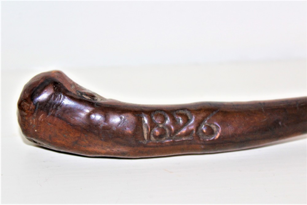 An early 19th-century curved wooden sailors fid featuring the carved date 1826 on its smooth polished body. View IV