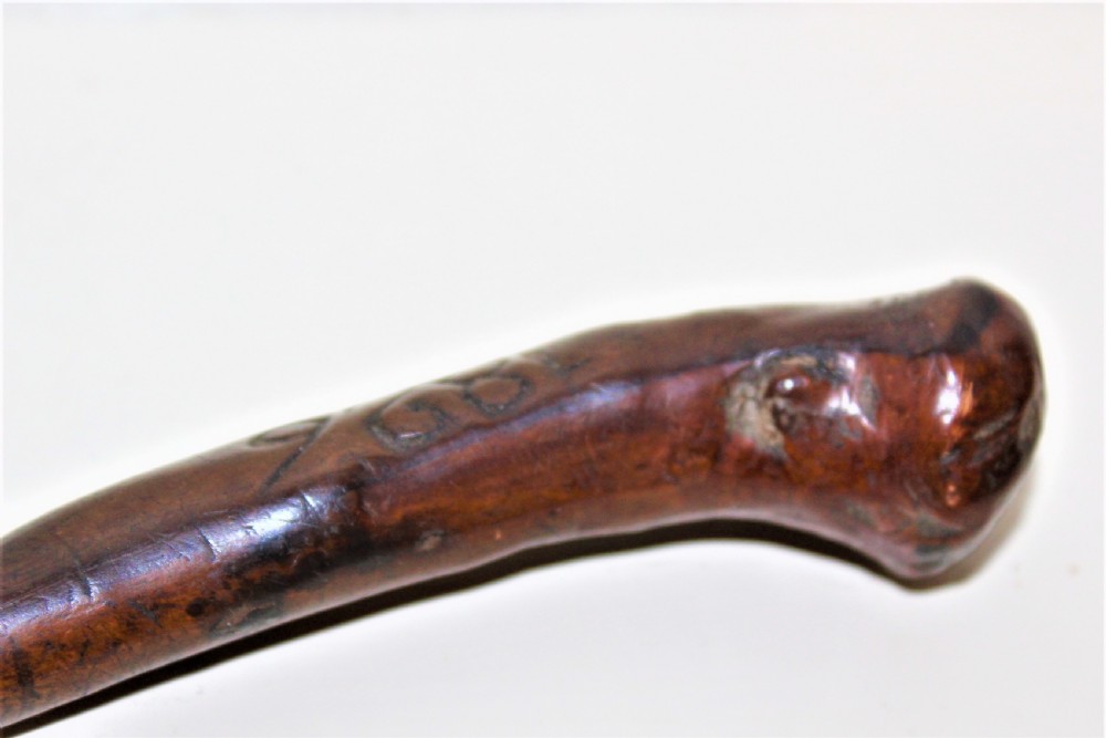An early 19th-century curved wooden sailors fid featuring the carved date 1826 on its smooth polished body. View VII