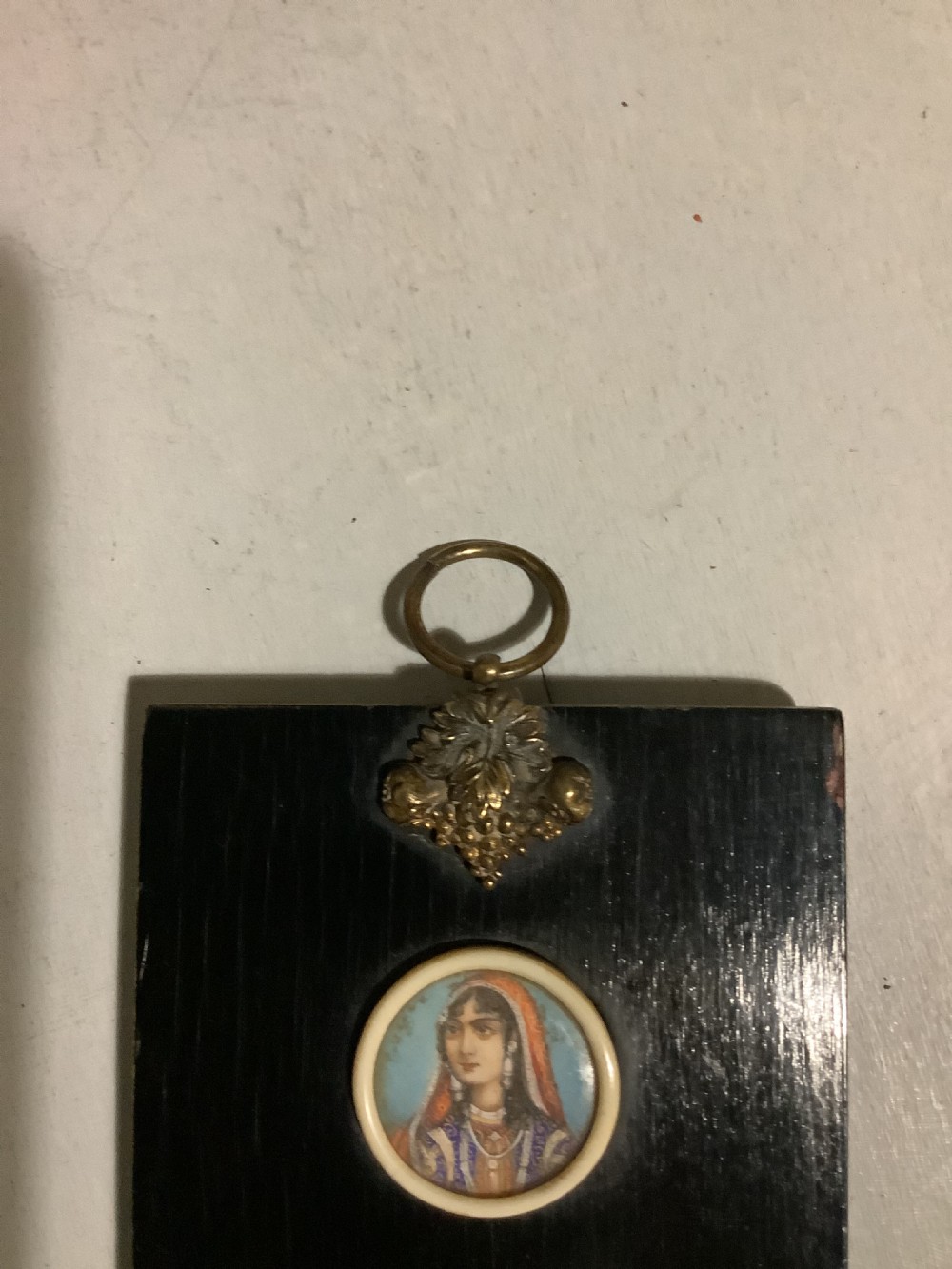 A small Indian ebonised wood painting of three miniatures finely painted on the back of the glass View IV