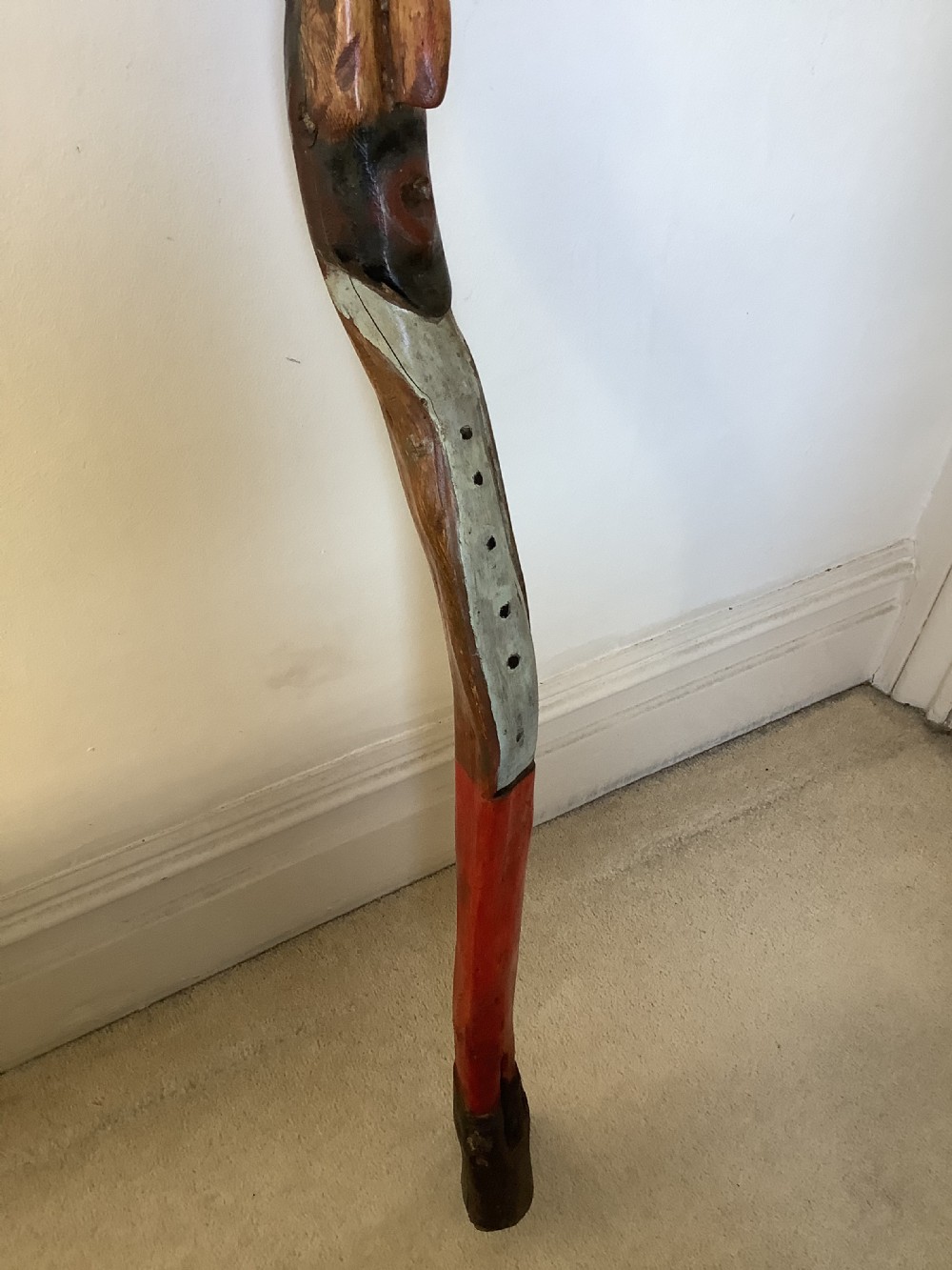 A hand-carved polychrome thorn wood walking stick featuring an anthropomorphic head and a painted red and grey shaft. View VI