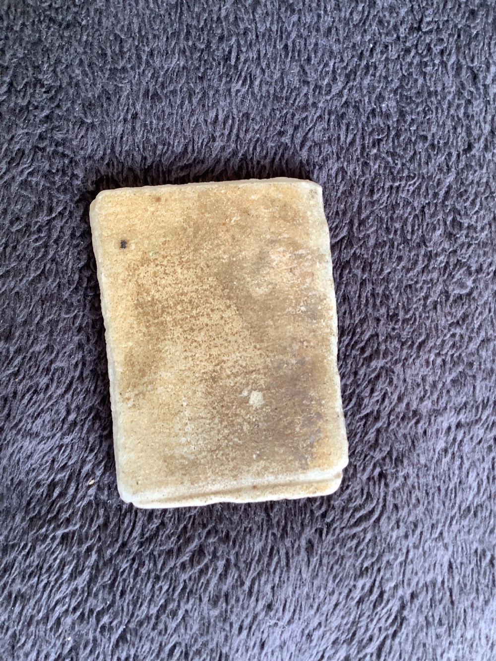 A rectangular carved marble plaque depicting the profile portrait of a Roman Emperor wearing a laurel wreath. View V