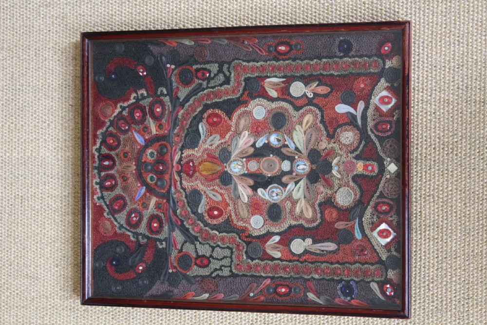 An antique framed 19th-century Indian quillwork picture featuring intricate red, black, and gold paper scrollwork embellished with beads and small painted portrait miniatures. View VIII