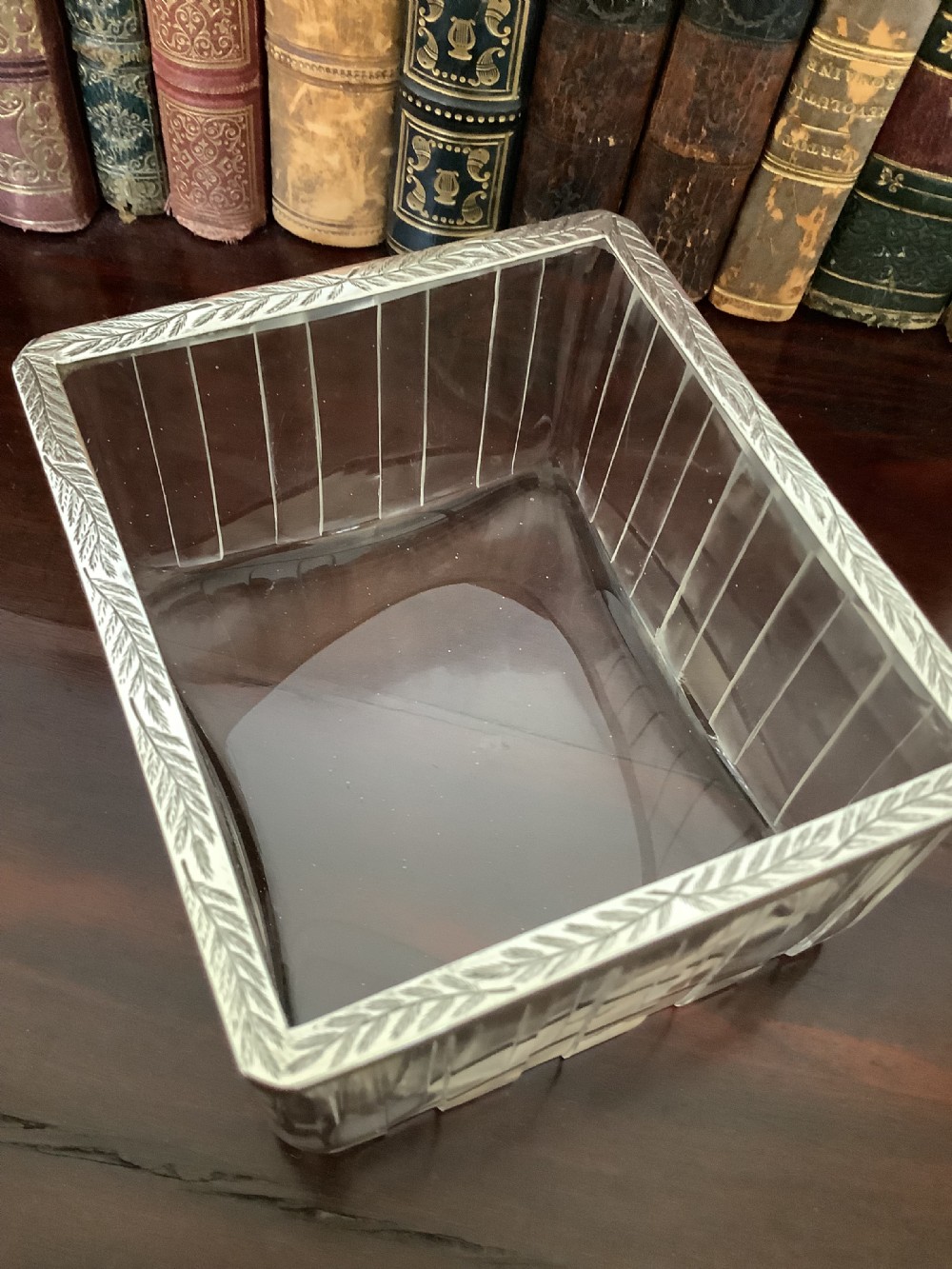 An antique silver and clear cut glass smoking compendium modelled in the form of a wheeled fire carriage with integrated lighter and storage compartments. View III