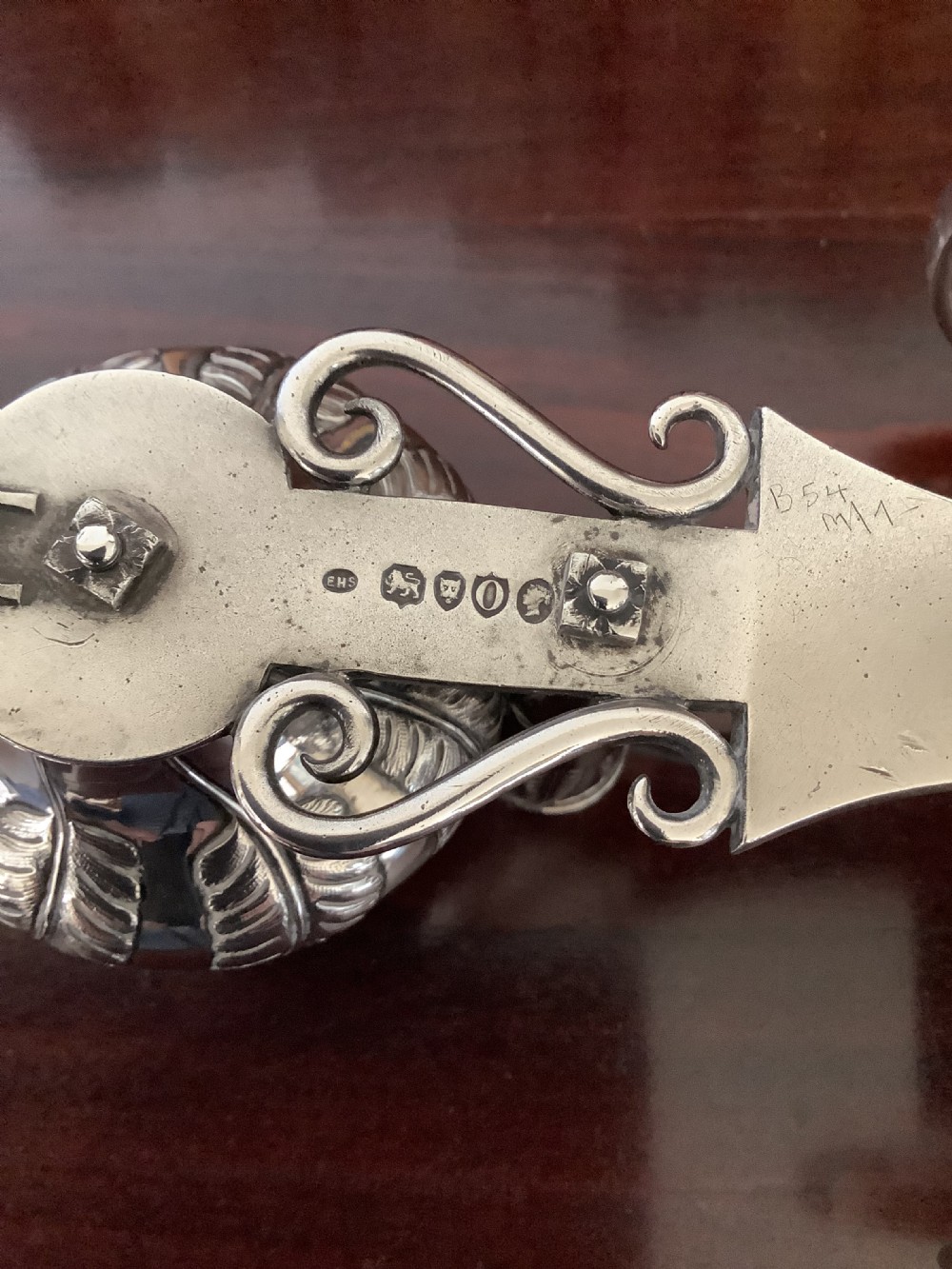 An antique silver and clear cut glass smoking compendium modelled in the form of a wheeled fire carriage with integrated lighter and storage compartments. View VI