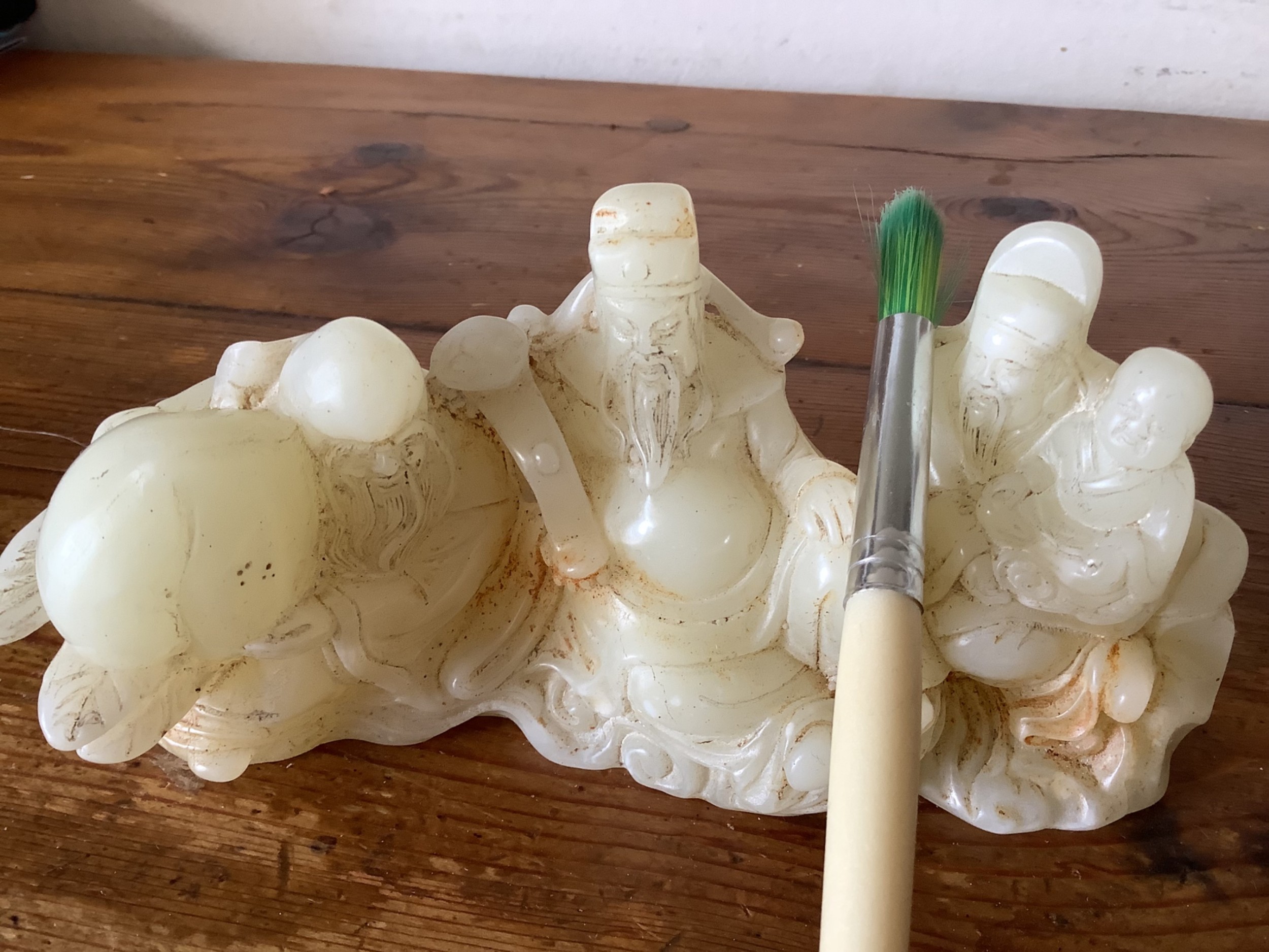 A finely carved Chinese hardstone possibly jade figural brush fest 