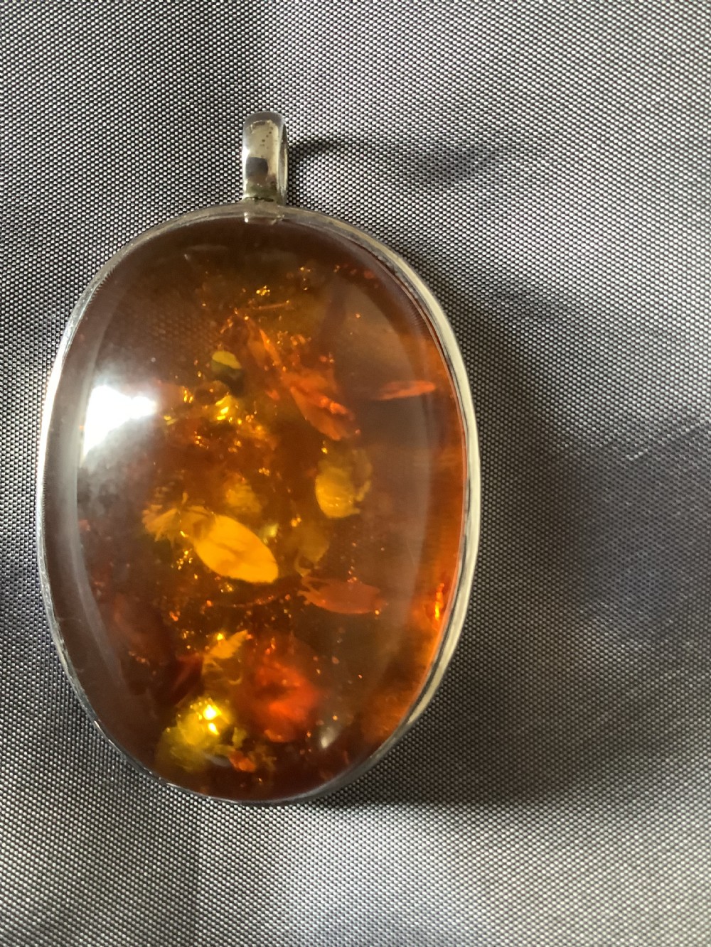 A wonderfully impressive large natural amber pendant a statement piece