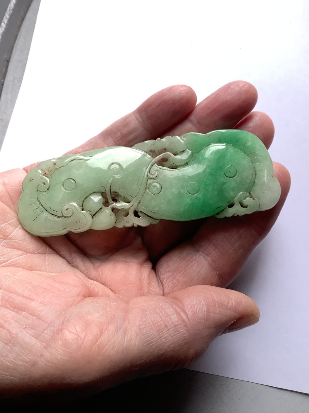 A very finely carved jade amulet in the form of a marine creature View III