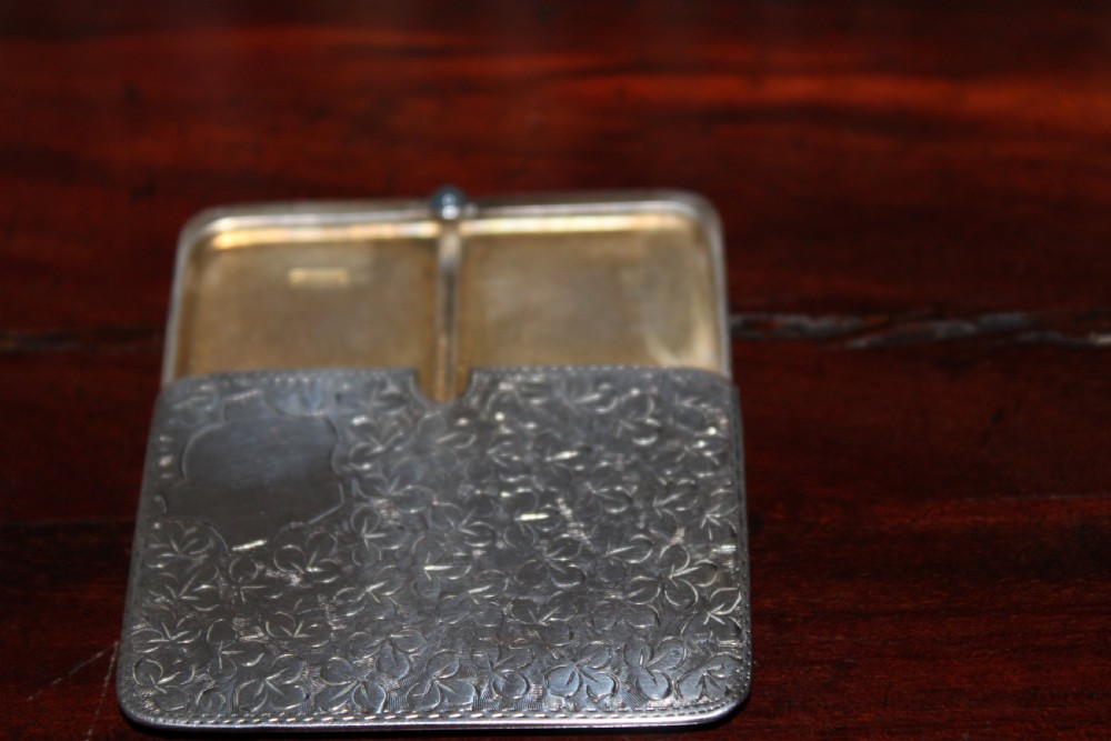 A small rectangular sterling silver stamp case featuring an engraved clover motif and a cabochon push clasp. View III