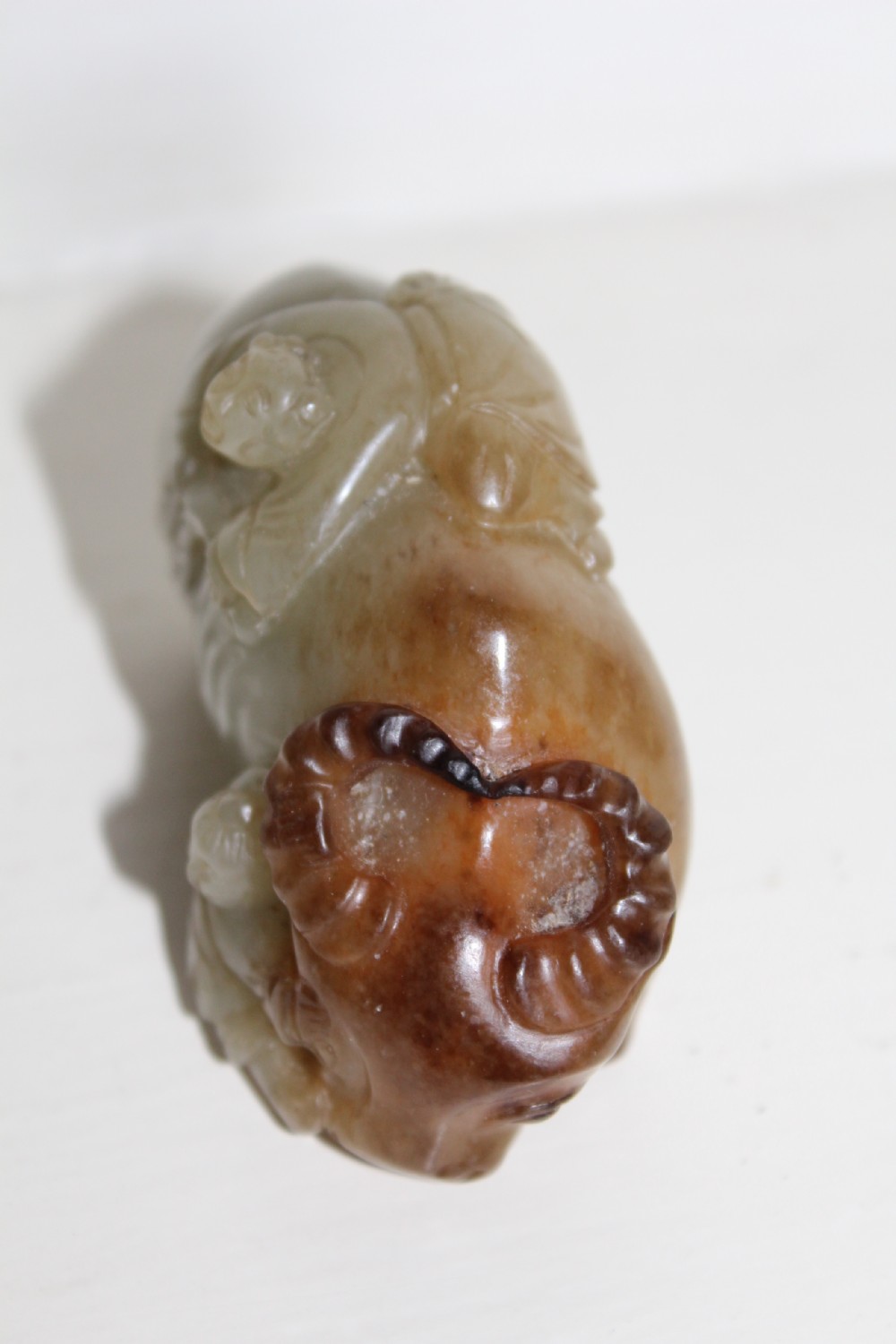 A finely carved pale green and russet jade buffalo  View VI
