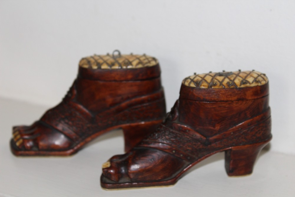 A pair of nineteenth-century carved wooden treen snuff boxes shaped like feet wearing heel shoes with bone toenails and cross-hatched inlaid lids. View VI