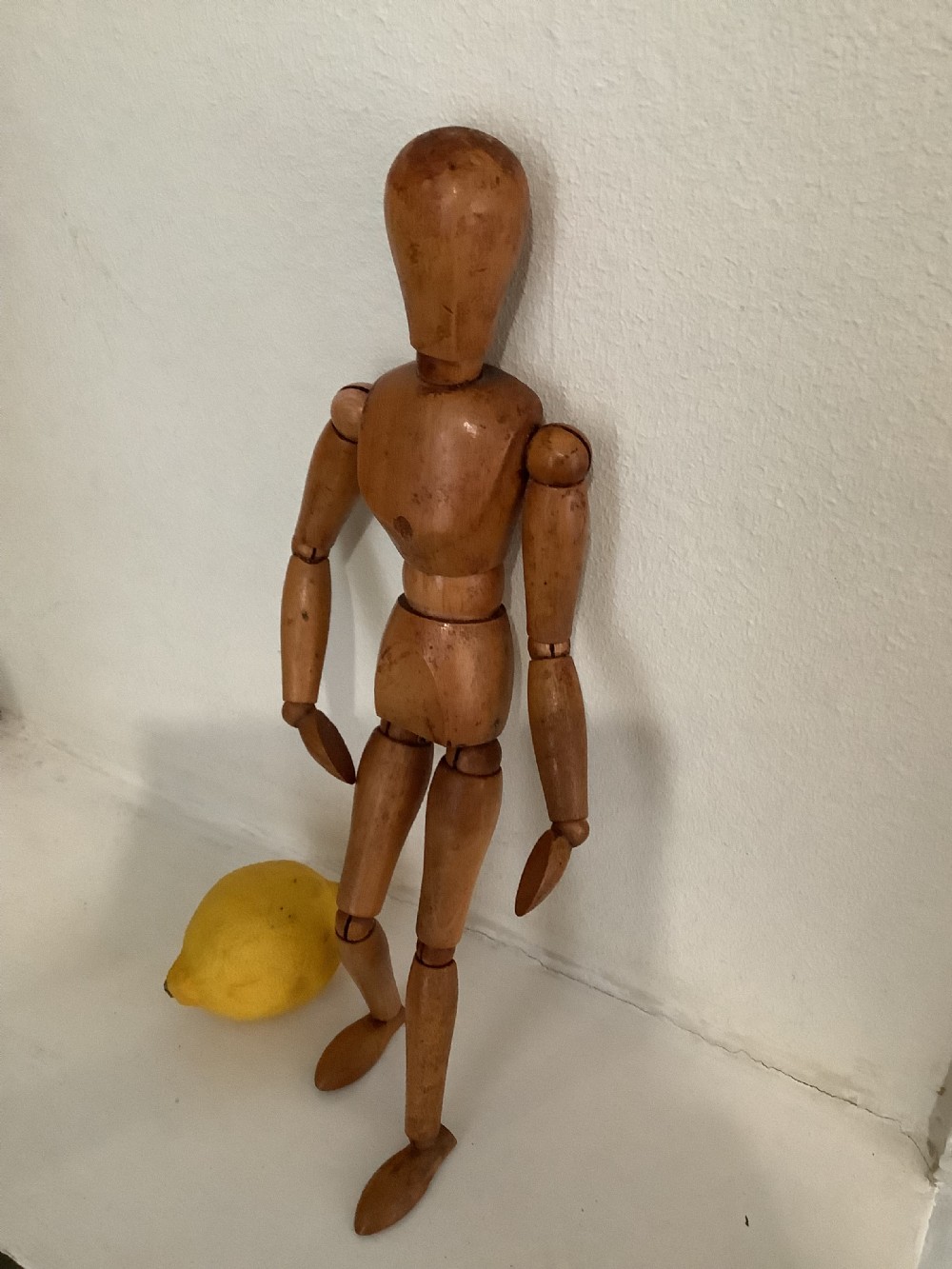An articulated wooden artist lay figure with ball and socket joints positioned standing upright. View VII
