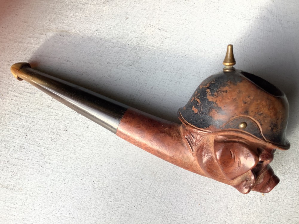 A carved wooden smoking pipe featuring a satirical pig head wearing a spiked helmet with the word Kultur inscribed on the stem. View VIII