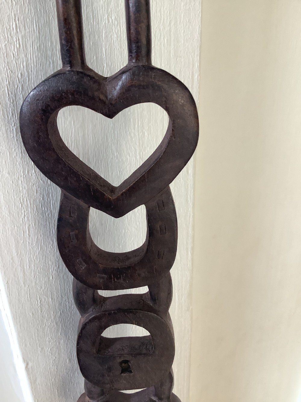 A very intricately carved wood Welsh love spoon carved from one piece of wood View II