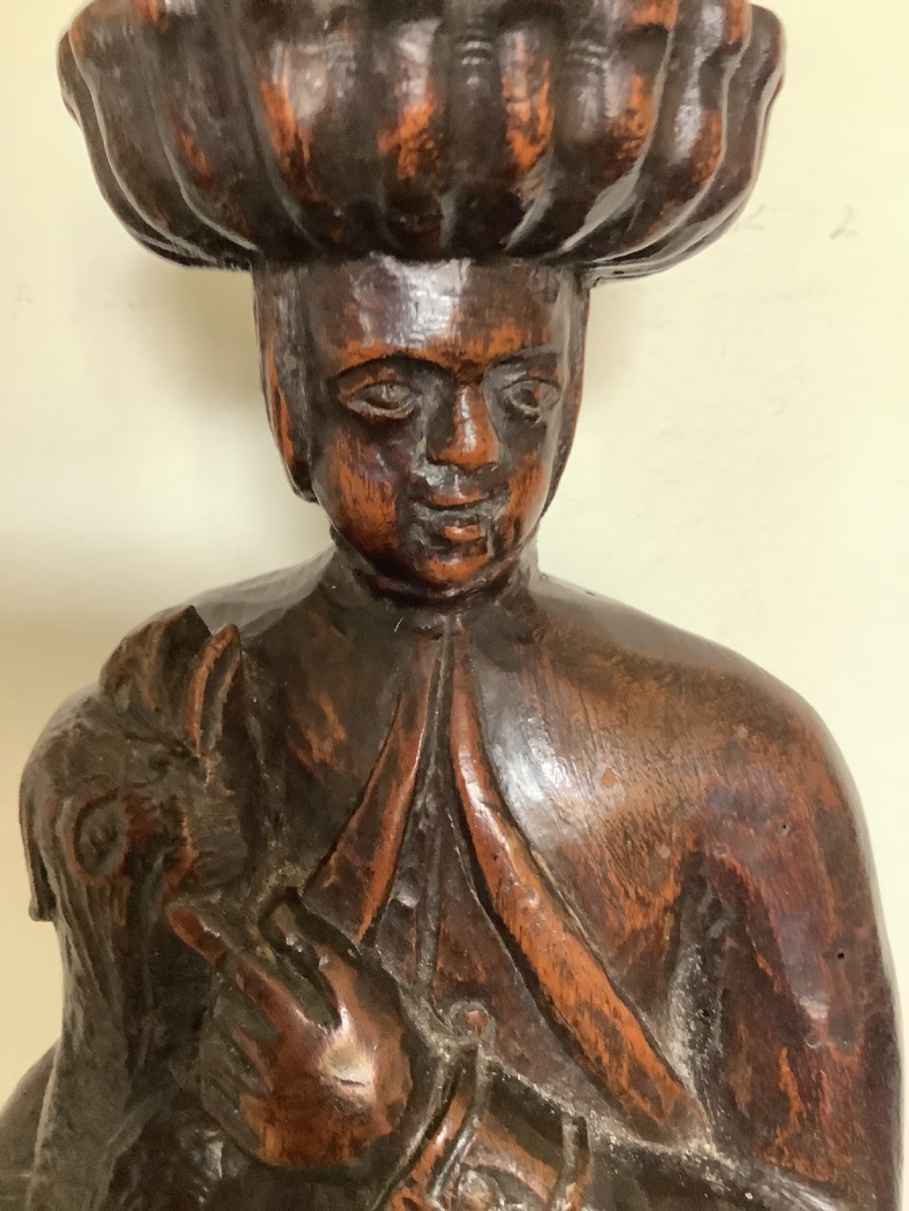 A pair of hand-carved dark wood candlesticks sculpted in the form of standing poachers holding game. View VIII