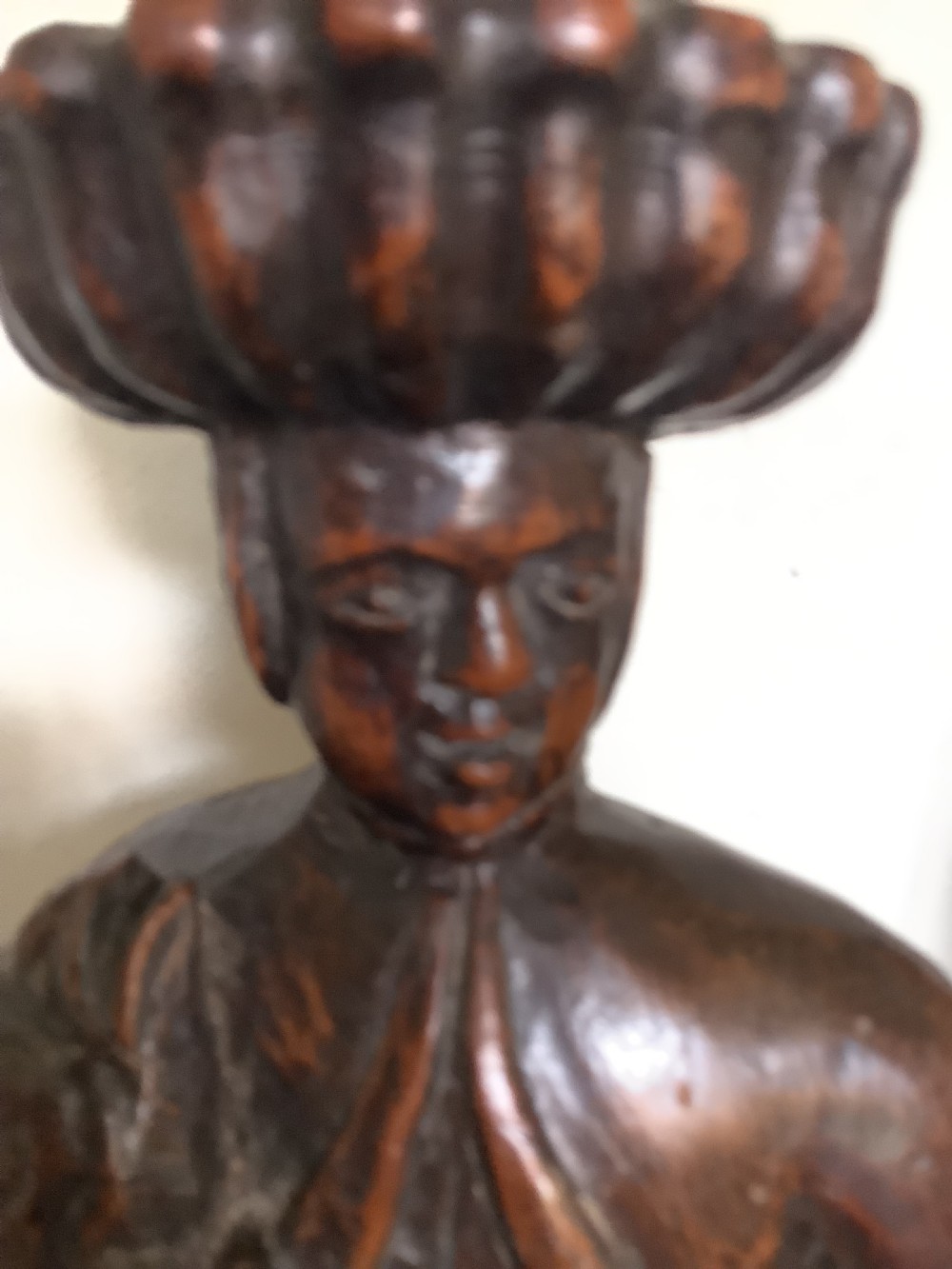 A pair of hand-carved dark wood candlesticks sculpted in the form of standing poachers holding game. View X