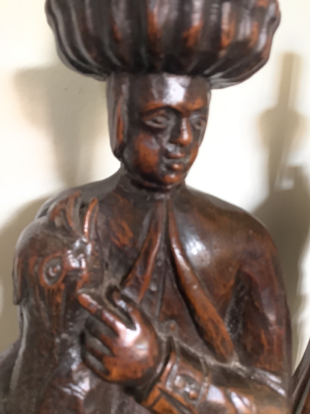 A pair of hand-carved dark wood candlesticks sculpted in the form of standing poachers holding game. View XI