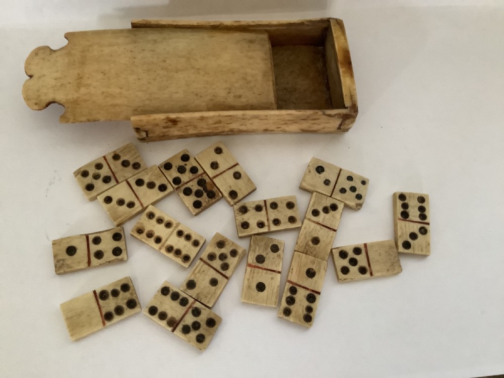 A very charming prisoner of war carved bone domino set in case 