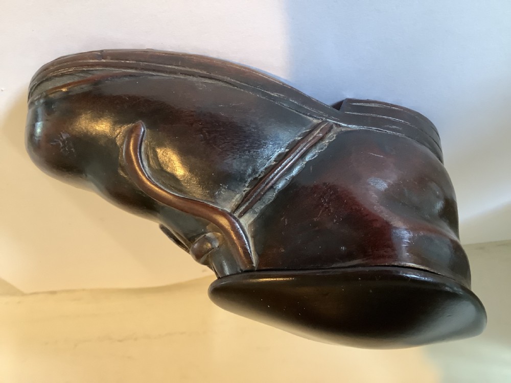 A carved dark hardwood table snuff box sculpted in the shape of a shoe with a fitted top lid and polished finish. View II