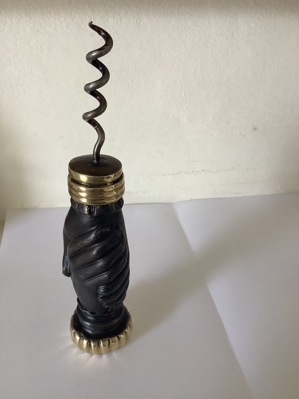 A cast brass and bronzed metal corkscrew featuring a handle formed in the shape of two clasped hands with a steel helix worm. View IV