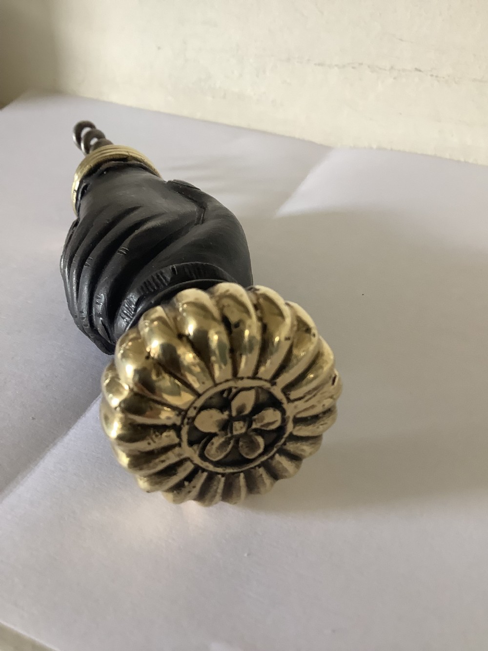 A cast brass and bronzed metal corkscrew featuring a handle formed in the shape of two clasped hands with a steel helix worm. View VI