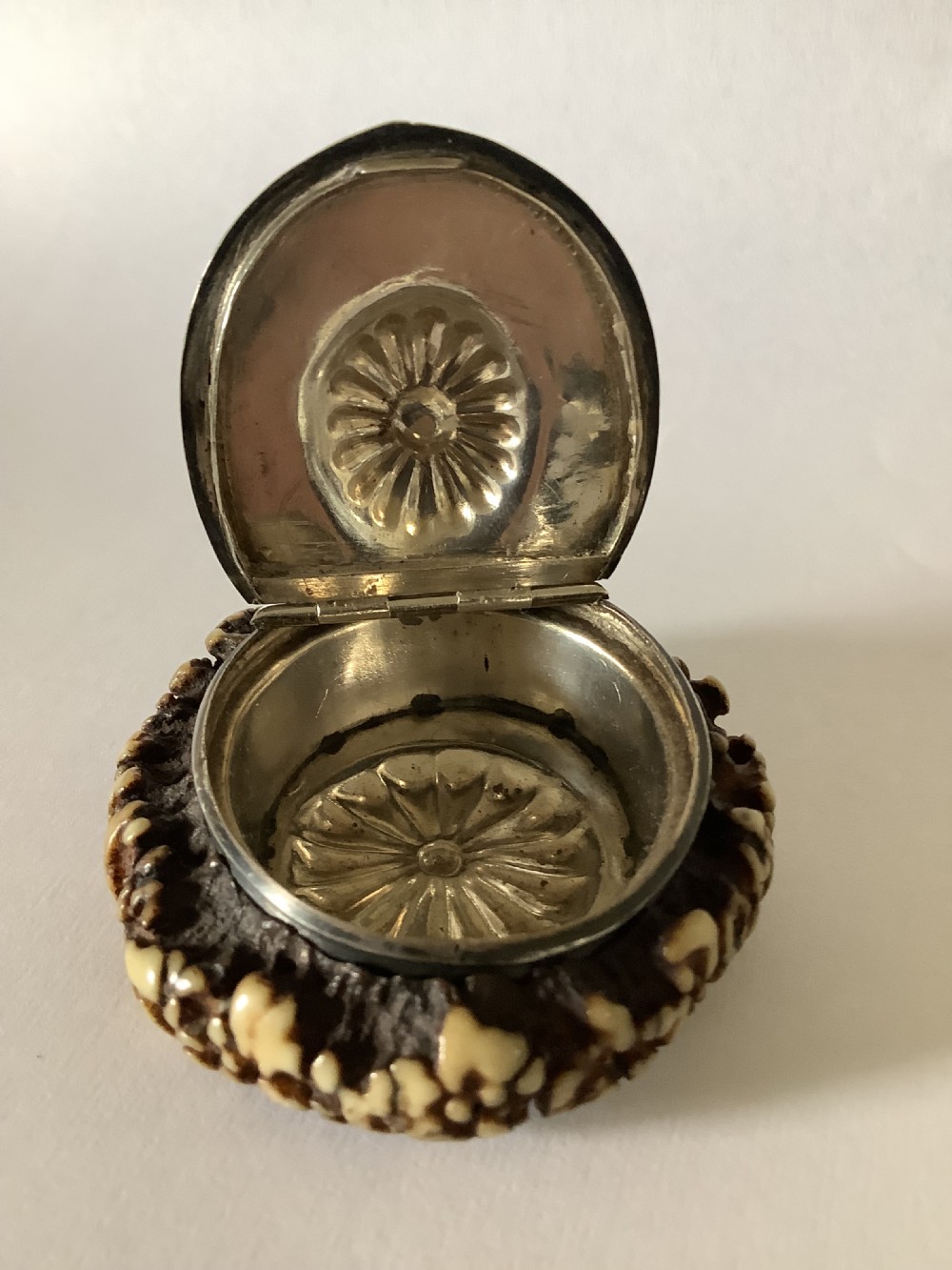 A 19th-century Scottish circular staghorn snuff box featuring a dark textured antler coronet base and a polished silver hinged lid with a fluted central motif. View II