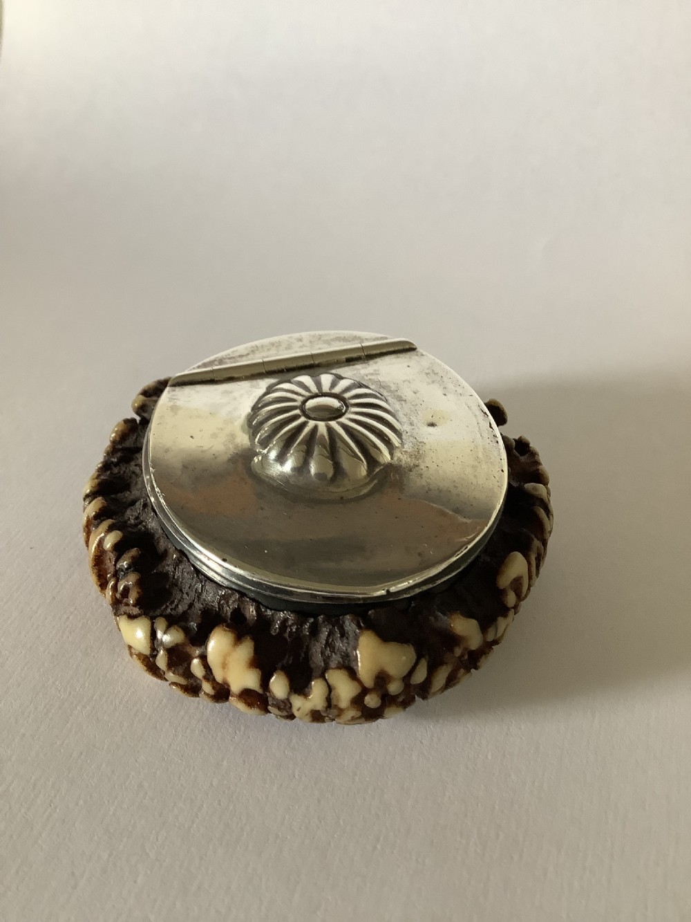 A 19th-century Scottish circular staghorn snuff box featuring a dark textured antler coronet base and a polished silver hinged lid with a fluted central motif. View VI