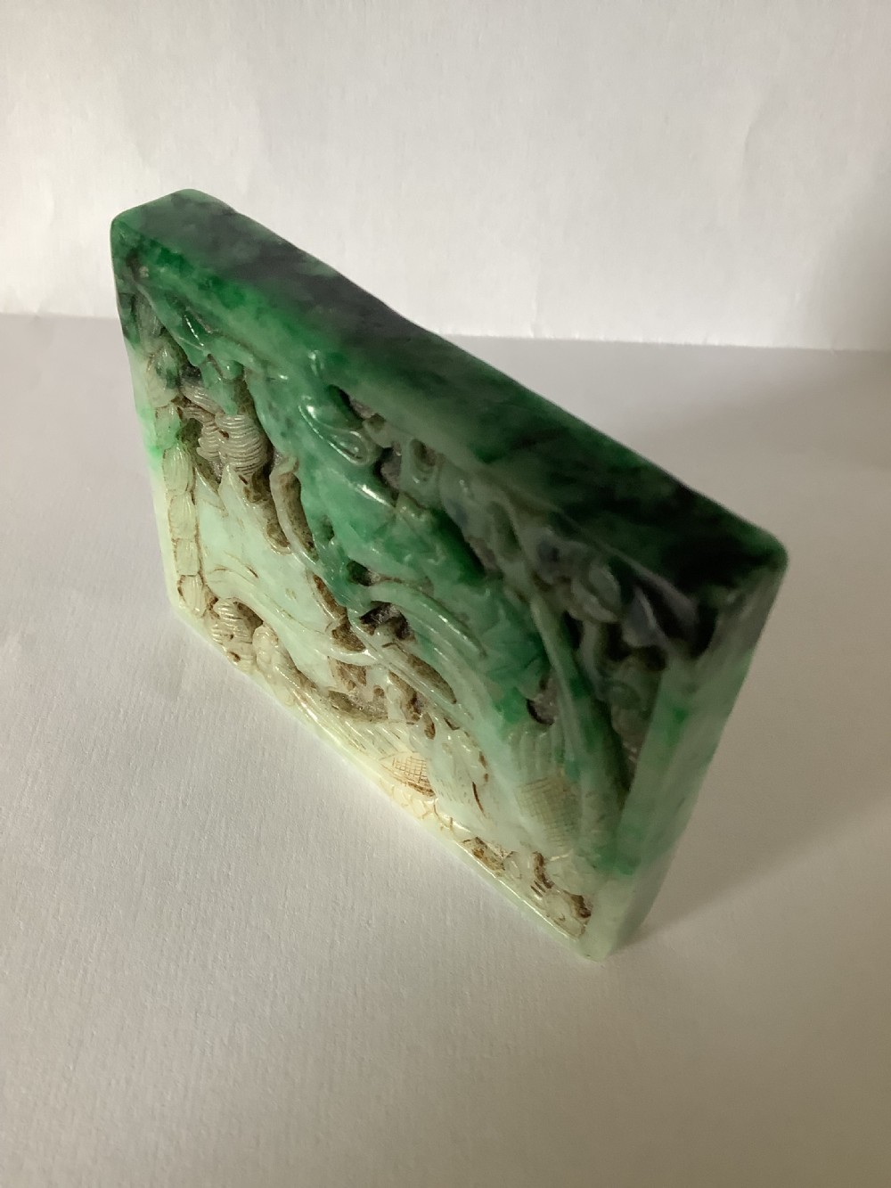 A rectangular openwork carved jade plaque featuring green and pale celadon tones with a carved bird and foliage motif. View VIII