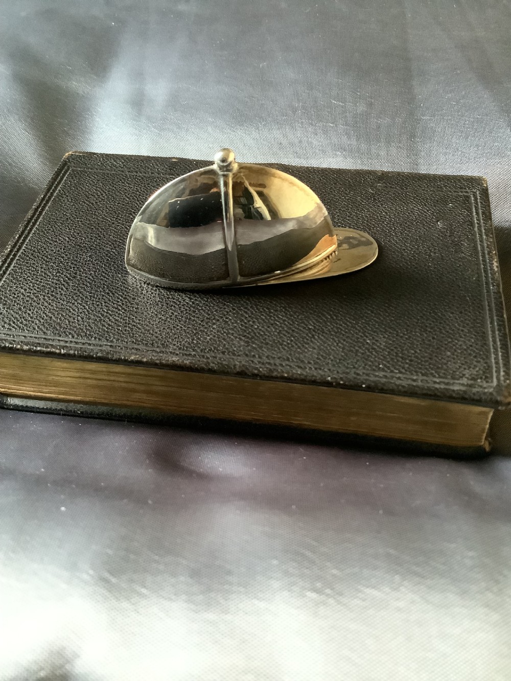 A sterling silver vesta case designed in the shape of an equestrian riding hat with a polished finish. View II
