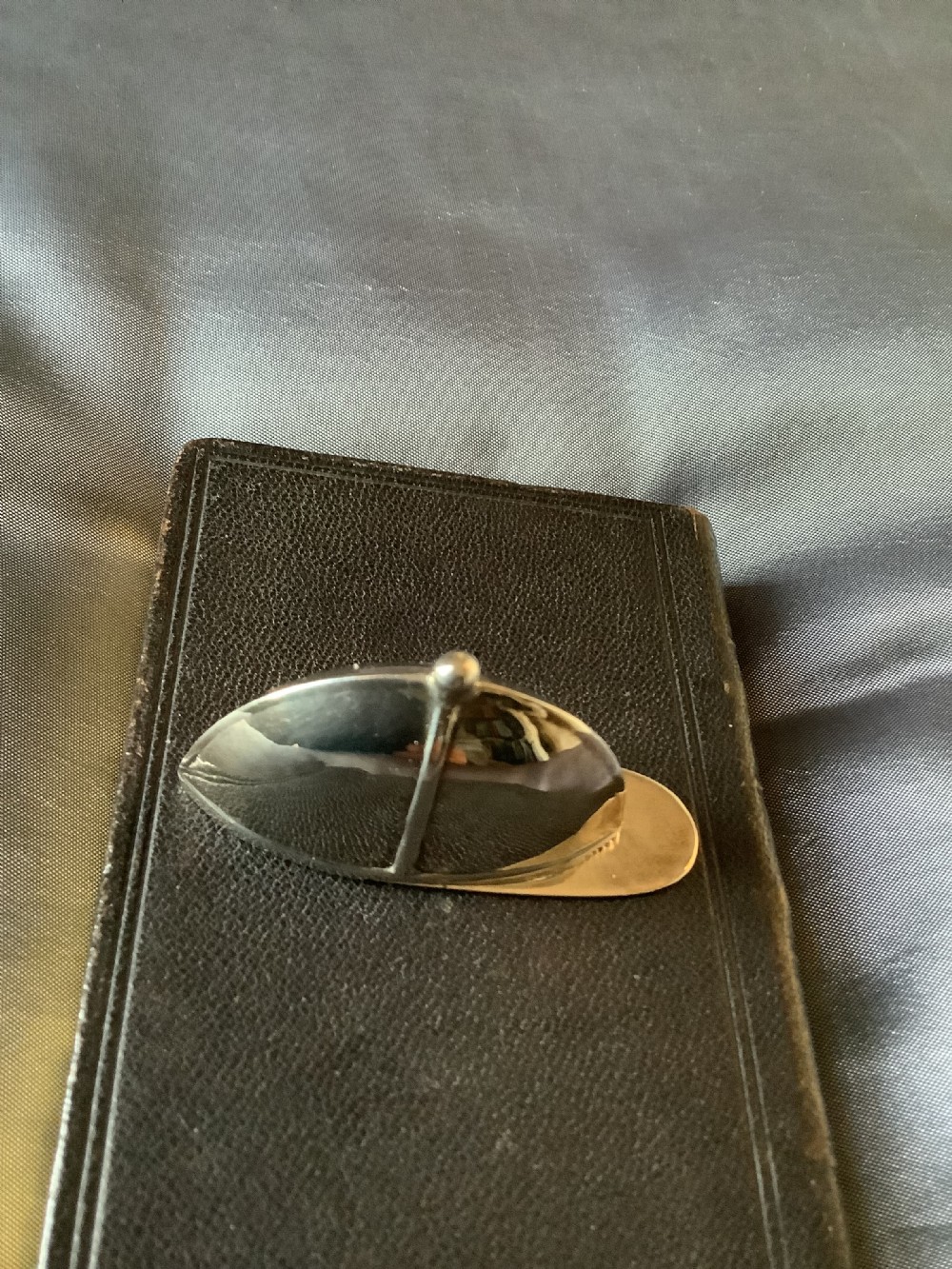 A sterling silver vesta case designed in the shape of an equestrian riding hat with a polished finish. View V