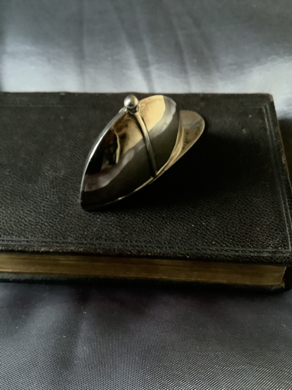 A sterling silver vesta case designed in the shape of an equestrian riding hat with a polished finish. View VI