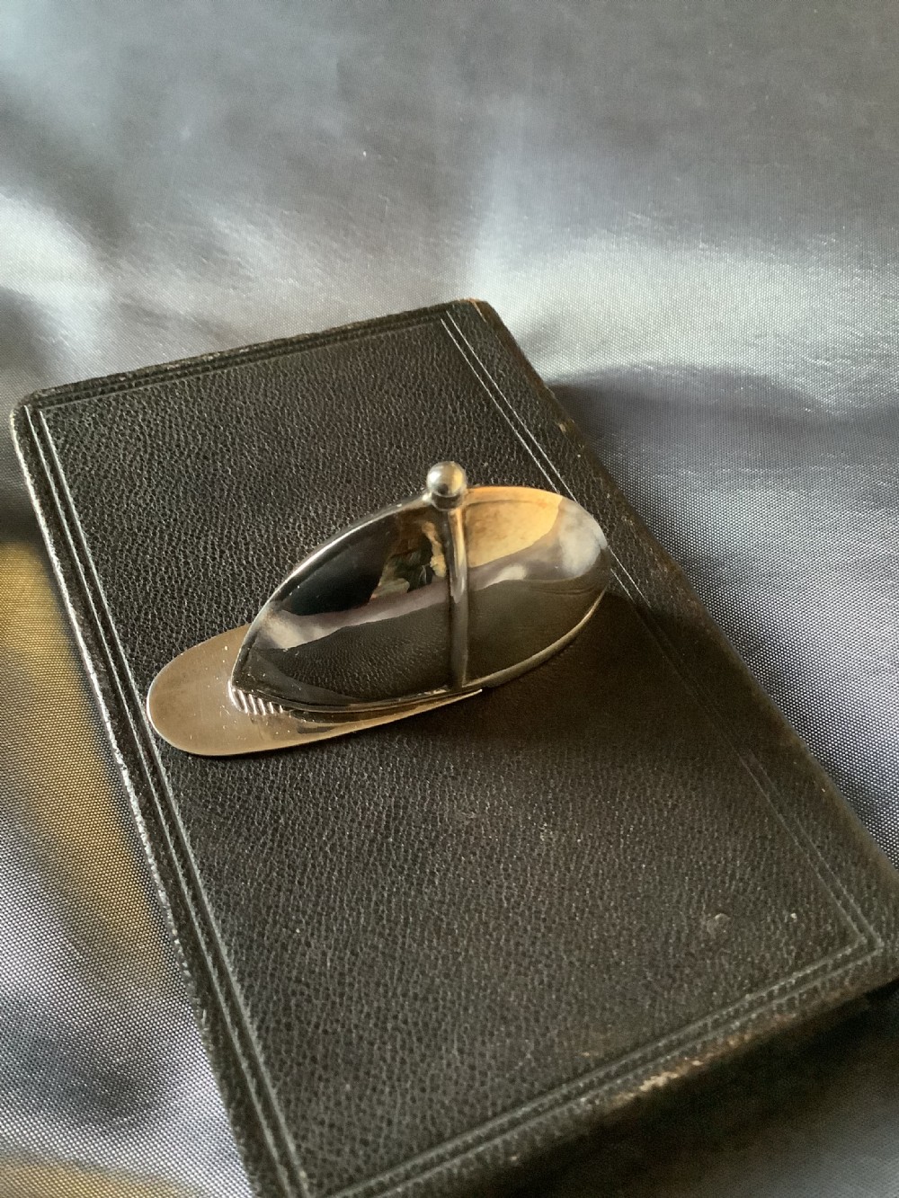 A sterling silver vesta case designed in the shape of an equestrian riding hat with a polished finish. View IX