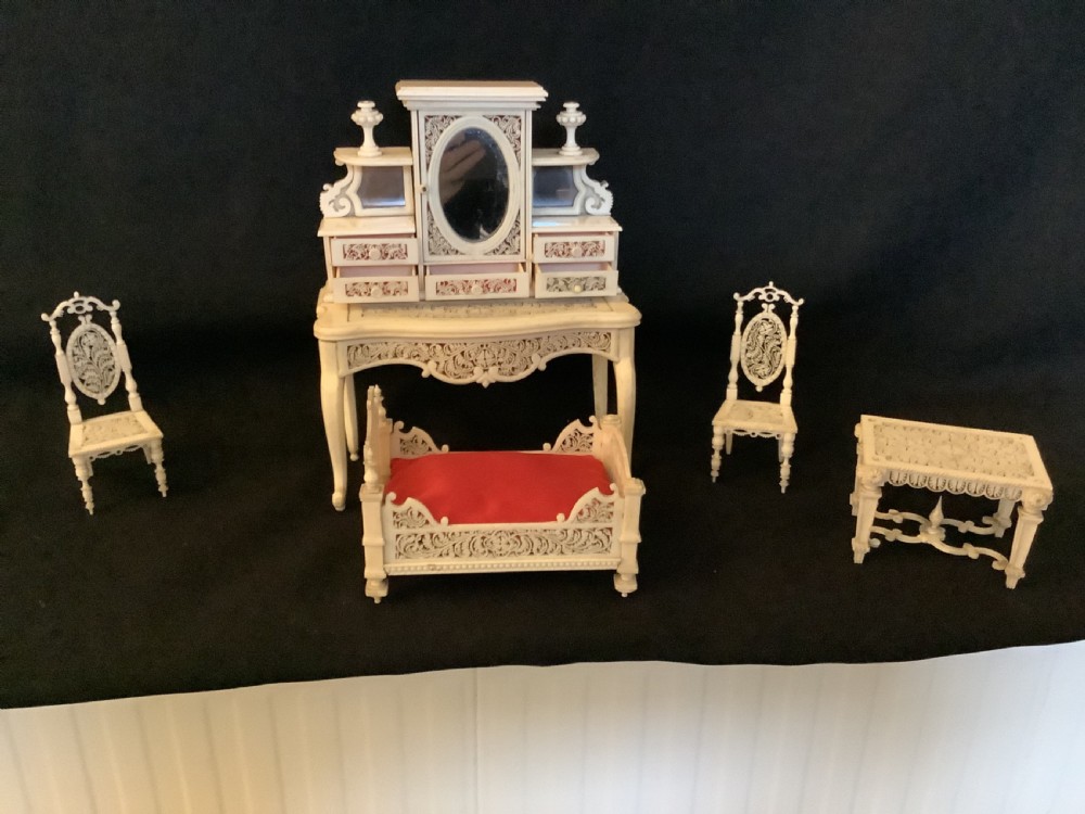 A miniature French carved bone boudoir suite featuring an ornate dressing table with mirror, a matching stool, and two side chairs with intricate pierced backs. View III