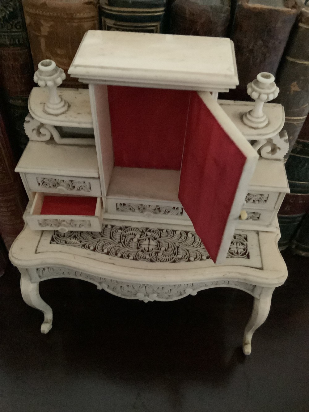 A miniature French carved bone boudoir suite featuring an ornate dressing table with mirror, a matching stool, and two side chairs with intricate pierced backs. View V