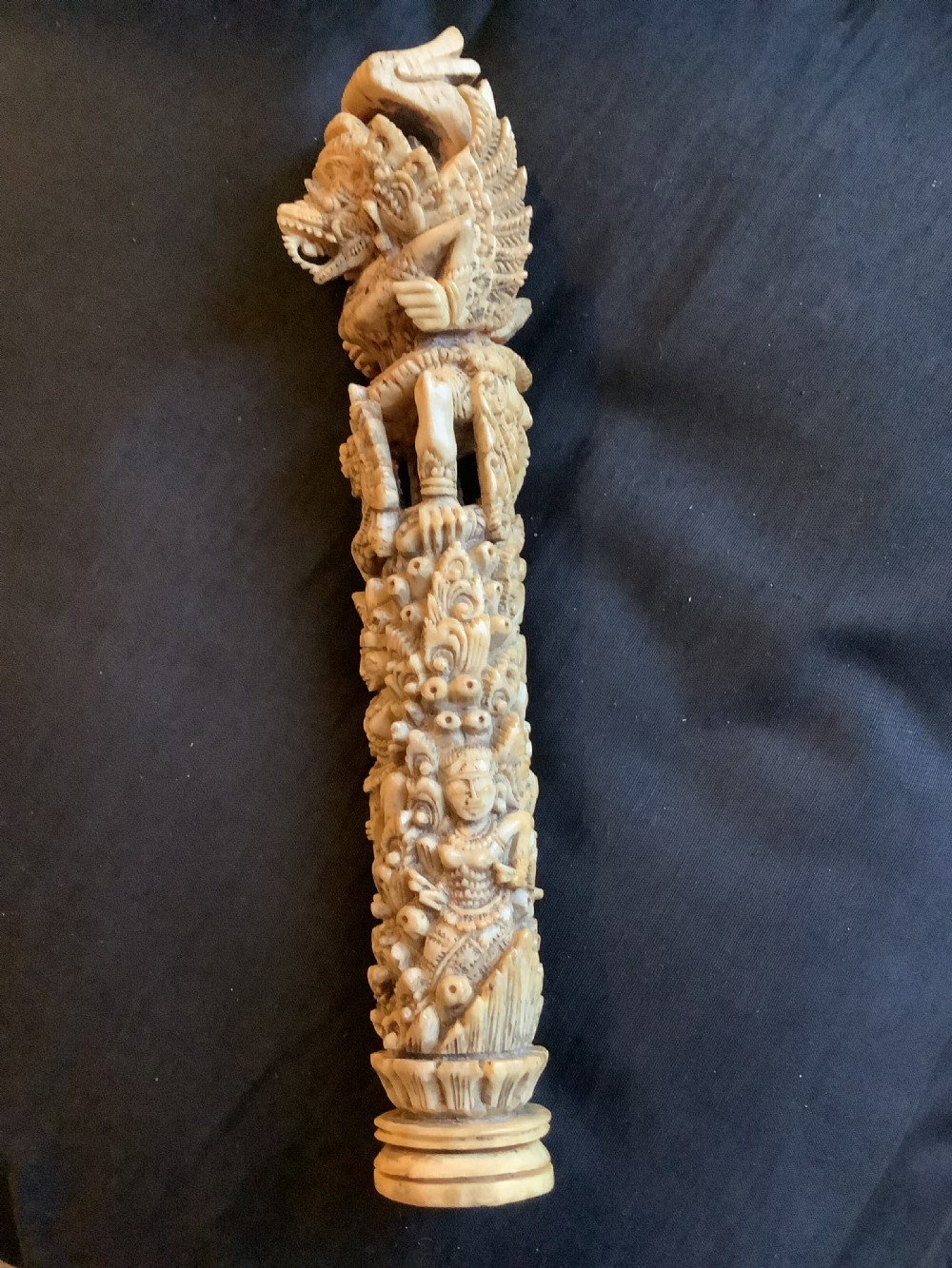 An intricately carved 19th-century sambar deer antler sword hilt featuring mythological figures and ornate traditional relief detailing. View II
