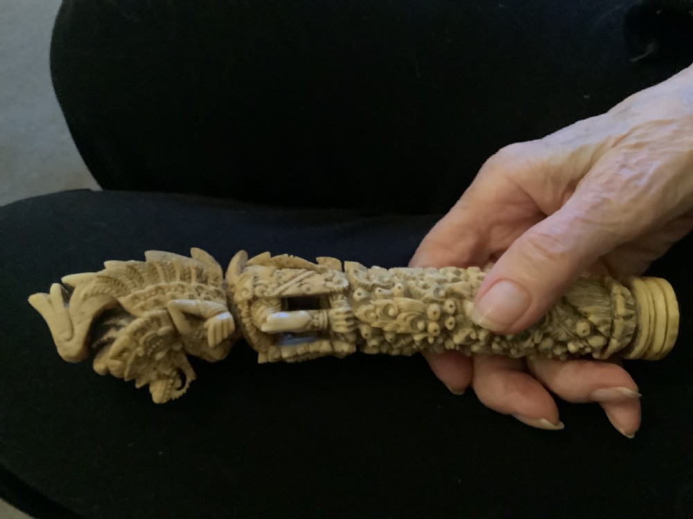An intricately carved 19th-century sambar deer antler sword hilt featuring mythological figures and ornate traditional relief detailing. View VII