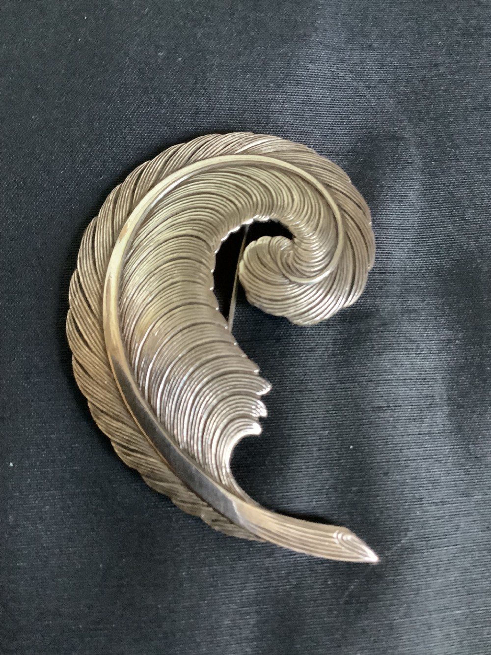 A very stylish and of a good size white metal brooch 