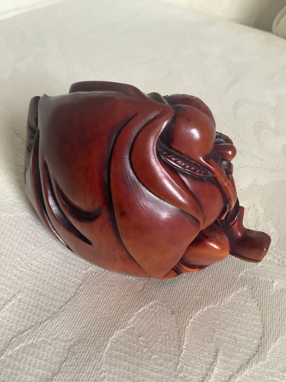 A Japanese hand-carved wooden figure depicting a bearded man in flowing robes with a smooth polished brown finish. View IV