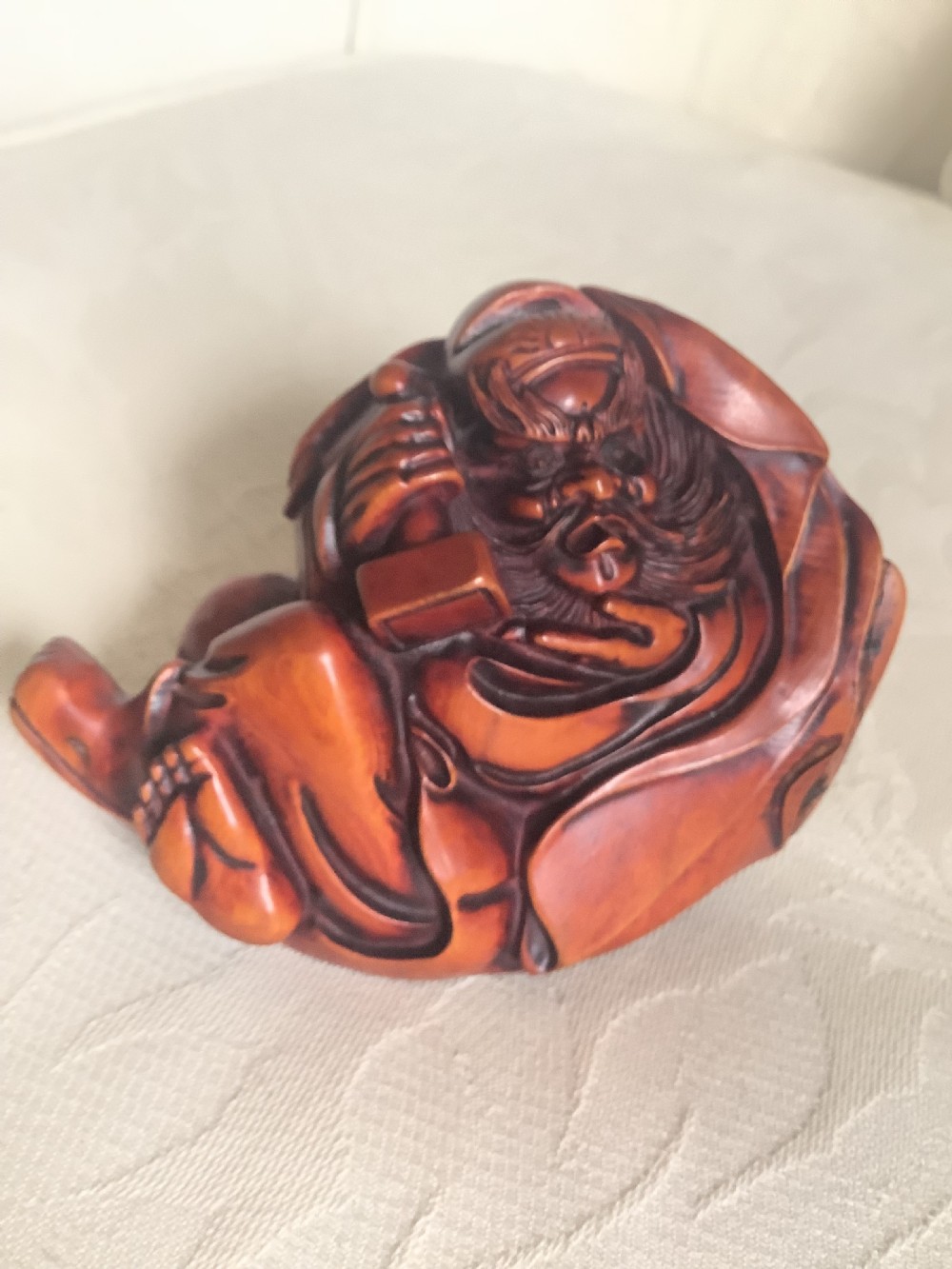A Japanese hand-carved wooden figure depicting a bearded man in flowing robes with a smooth polished brown finish. View VII