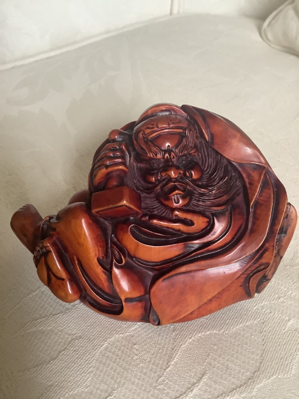 A Japanese hand-carved wooden figure depicting a bearded man in flowing robes with a smooth polished brown finish. View VIII