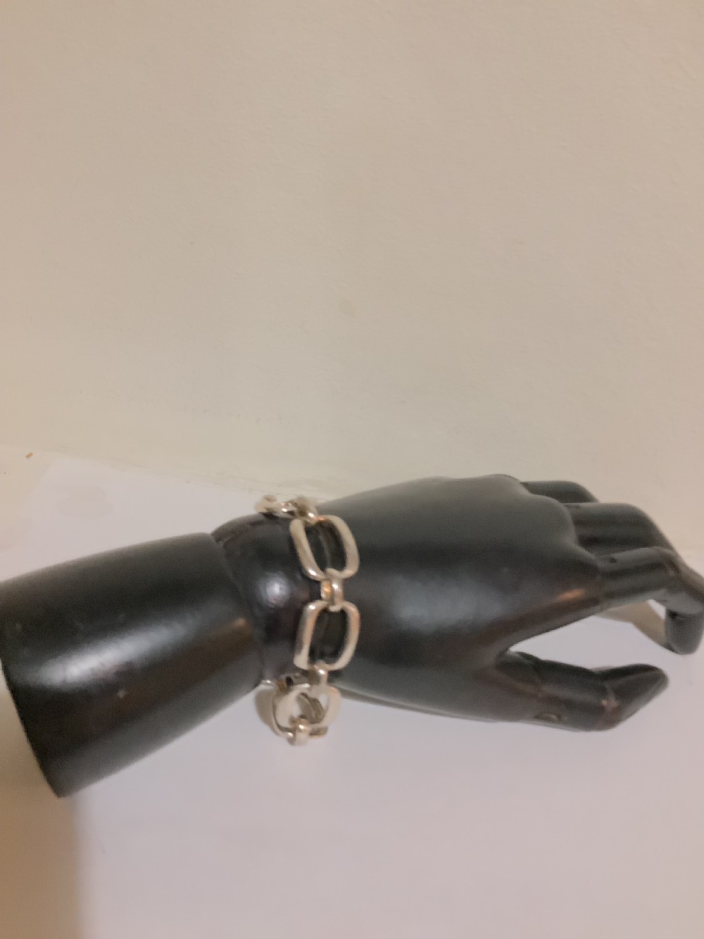 An Art Deco silver chain link bracelet featuring elongated openwork rectangular links. View V
