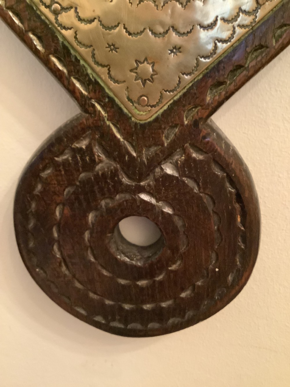 An antique brass sundial and world clock plaque mounted on a carved dark wooden backboard, featuring engraved Roman numerals and global place names. View IV